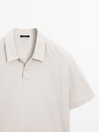Short sleeve polo shirt with snap-button placket