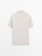 Short sleeve polo shirt with snap-button placket