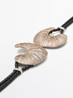 Leather belt with fossil buckle