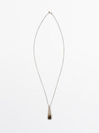 Geometric pendant with stone