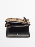 Animal print hair on leather wallet