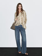 Snakeskin print blouse with ruffles