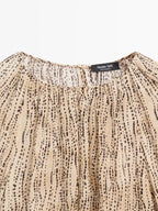 Semi-sheer draped blouse