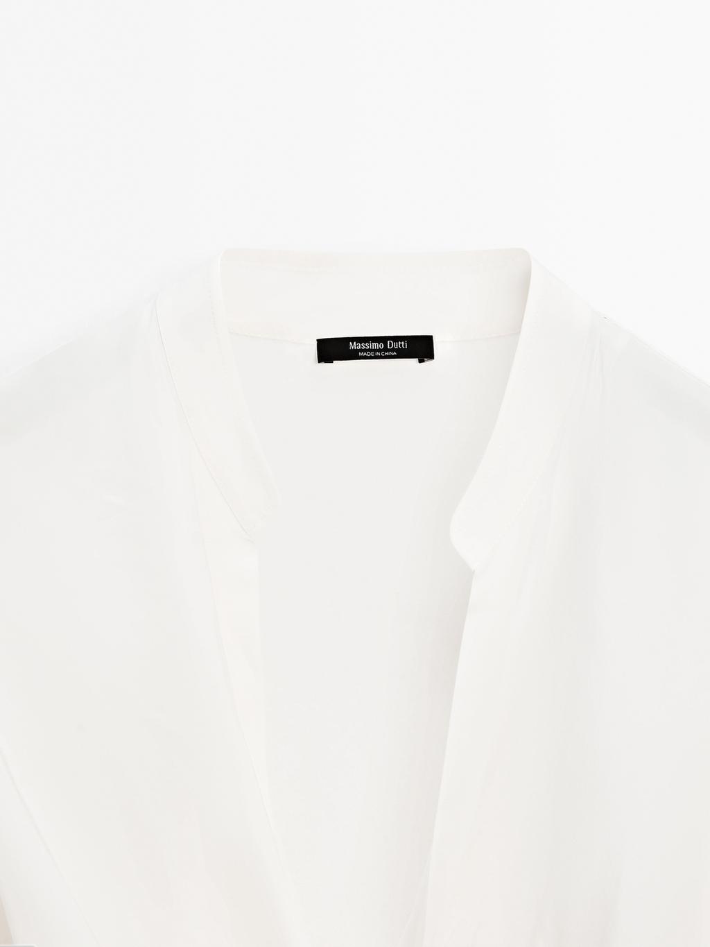 Blouse with knotted neckline and brooch detail