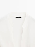 Blouse with knotted neckline and brooch detail