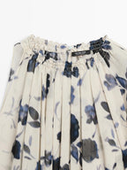 Asymmetric flowing floral print blouse