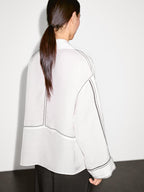 Loose-fitting blouse with contrast details