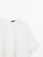 Short cape with seam details