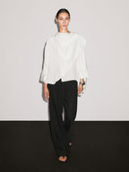 Short flowing cape with sleeve detail