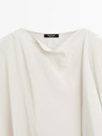 Short flowing cape with sleeve detail