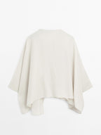 Short flowing cape with sleeve detail