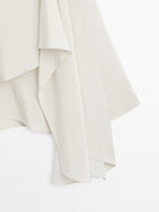Short flowing cape with sleeve detail