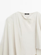 Short flowing cape with sleeve detail