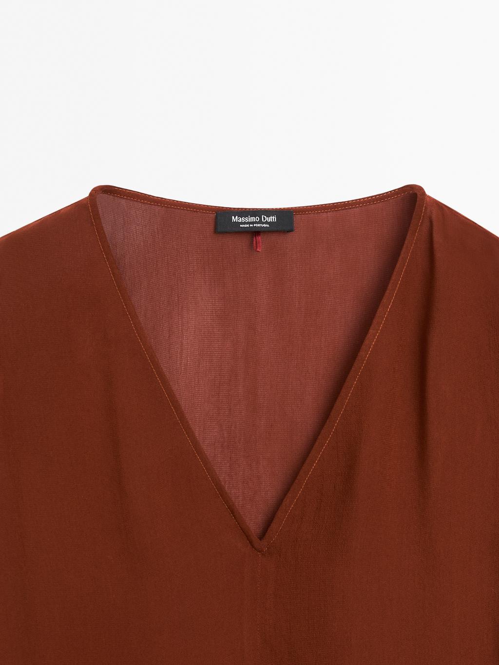 Cape-style blouse with ruffles
