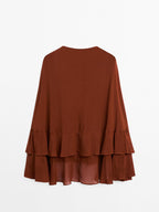 Cape-style blouse with ruffles