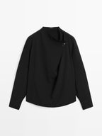 Blouse with crossover detail and button