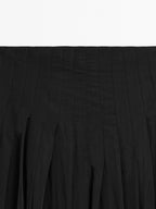 Flowing midi skirt with box pleats