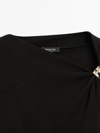 Sleeveless draped top with shoulder applique