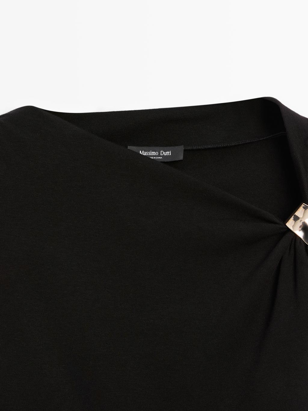 Sleeveless draped top with shoulder applique