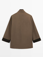 Waxed high neck parka with corduroy detail