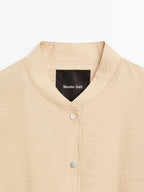 Loose-fitting bomber jacket with drawstring detail