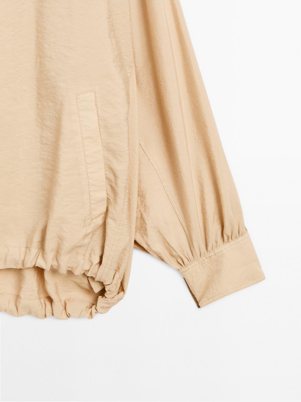 Loose-fitting bomber jacket with drawstring detail
