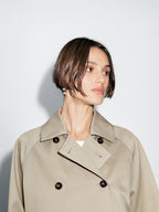 Short trench coat with button detail on the collar