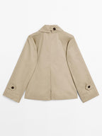 Short trench coat with button detail on the collar